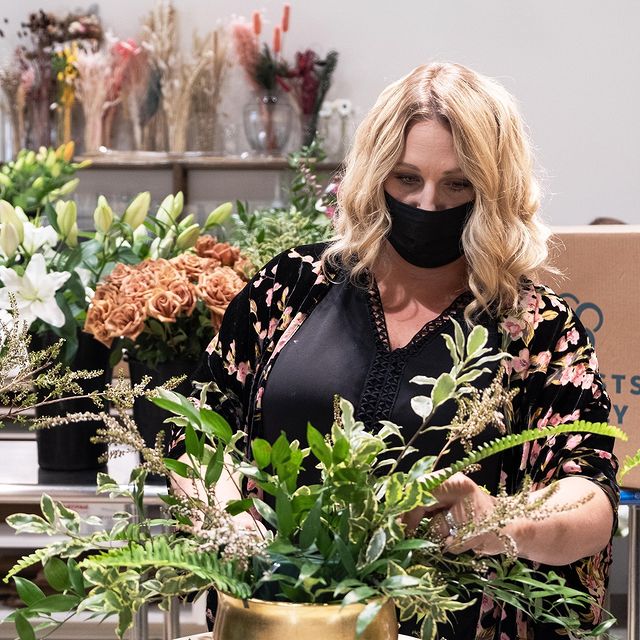 Julie Myers of the Floral Fixx designing a fall arrangement